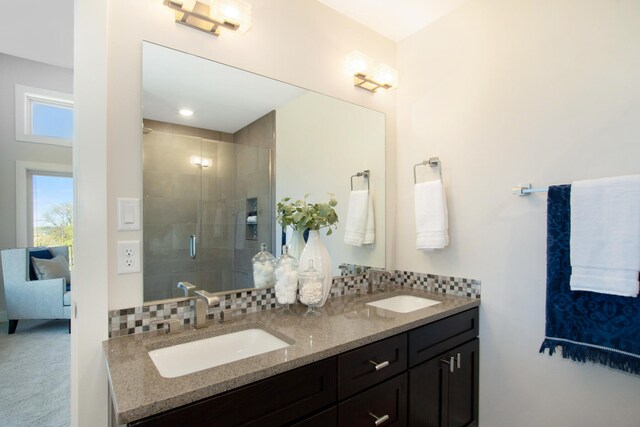 631 Fairview Ave NE Unit 3, Grand Rapids, MI 49503 - bathroom with backsplash, a stall shower, and a sink