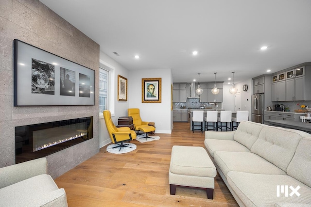631 Fairview Ave NE Unit 3, Grand Rapids, MI 49503 - living area featuring light wood finished floors, visible vents, baseboards, recessed lighting, and a fireplace