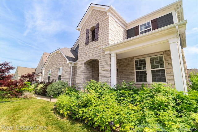 2959 Montgomery Cir, Walled Lake, MI 48390 - view of front of home featuring stone siding and a front yard