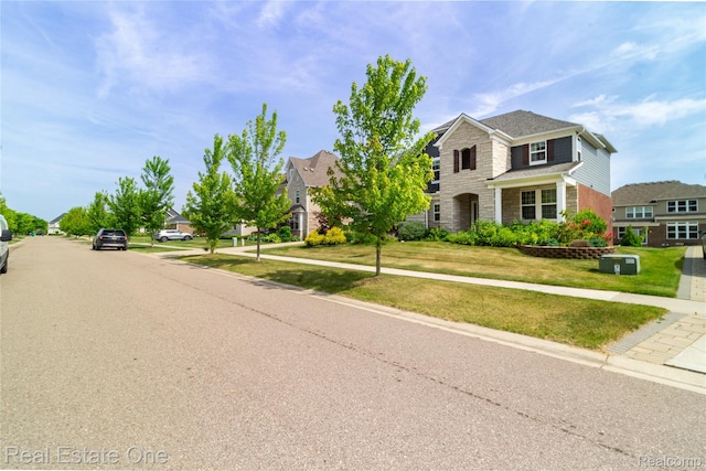 2959 Montgomery Cir, Walled Lake, MI 48390 - view of front of home featuring a front yard, a residential view, brick siding, and stone siding