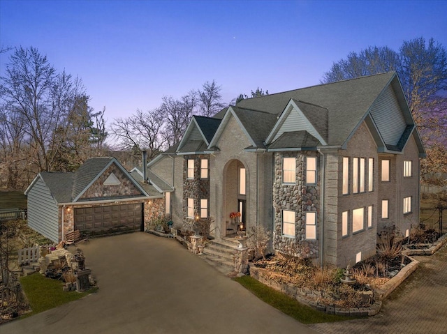 1270 John R Rd, Rochester Hills, MI 48307 - view of front facade featuring a garage, stone siding, and driveway
