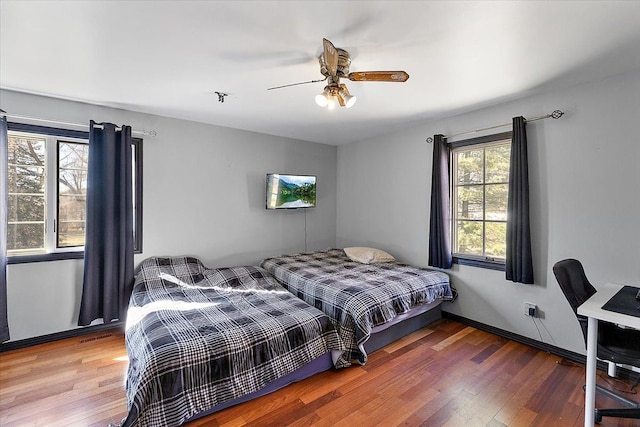 1270 John R Rd, Rochester Hills, MI 48307 - bedroom featuring baseboards, wood finished floors, and a ceiling fan