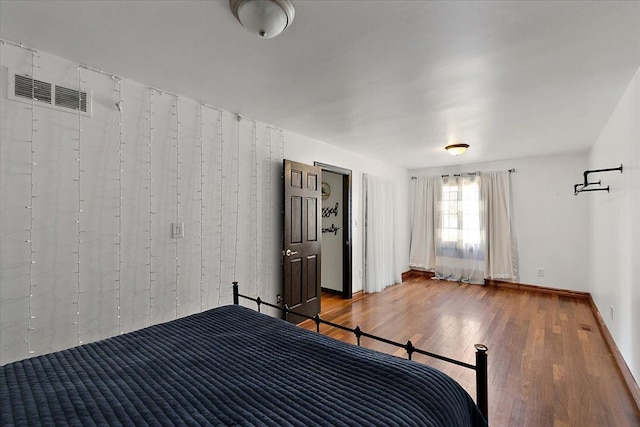 1270 John R Rd, Rochester Hills, MI 48307 - unfurnished bedroom featuring visible vents, baseboards, and wood finished floors
