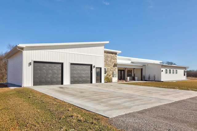 5595 Riverview Dr, Bridgeport, MI 48722 - contemporary home featuring a garage and stone siding