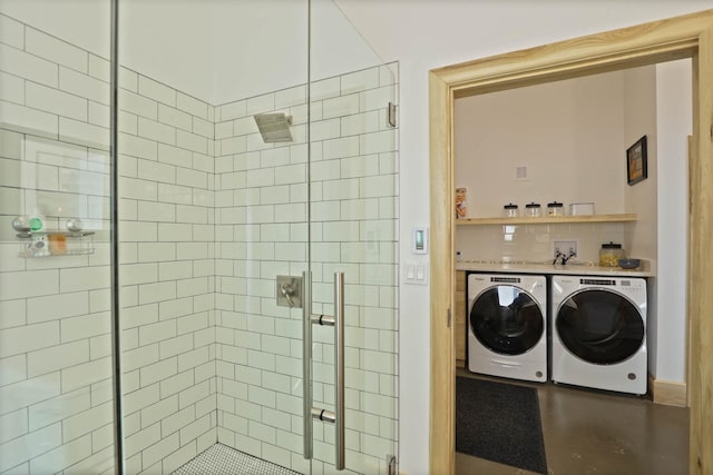 5595 Riverview Dr, Bridgeport, MI 48722 - full bath with washing machine and dryer, a stall shower, and decorative backsplash