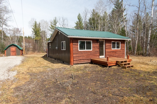 2340 Ryno Rd, Luzerne, MI 48636 - chalet / cabin featuring a wooden deck, metal roof, and an outdoor structure