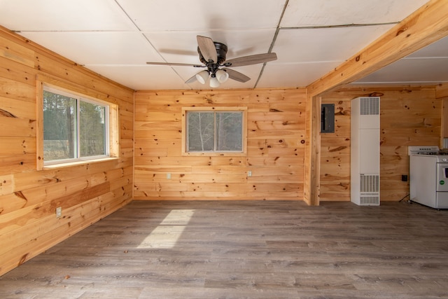 2340 Ryno Rd, Luzerne, MI 48636 - empty room with electric panel, wood finished floors, wood walls, and ceiling fan