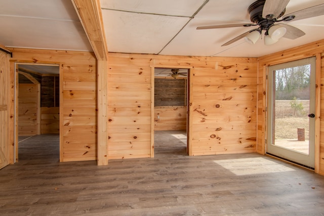 2340 Ryno Rd, Luzerne, MI 48636 - spare room featuring wood finished floors, a ceiling fan, and wood walls
