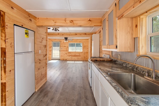 2340 Ryno Rd, Luzerne, MI 48636 - kitchen with white appliances, wooden walls, wood finished floors, beam ceiling, and a sink