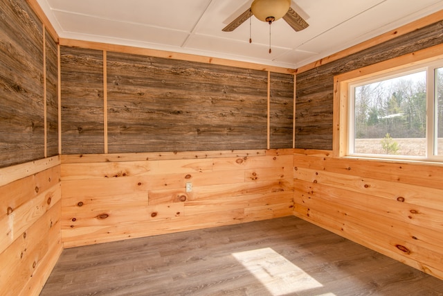 2340 Ryno Rd, Luzerne, MI 48636 - empty room with wood finished floors, wood walls, and a ceiling fan