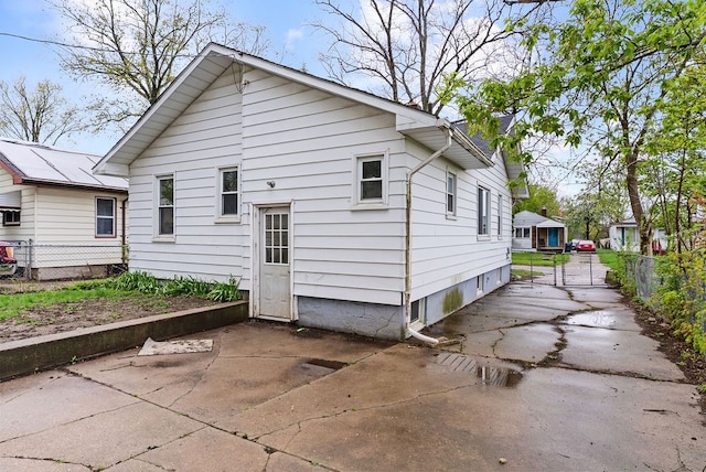 rear view of house with fence and a patio area