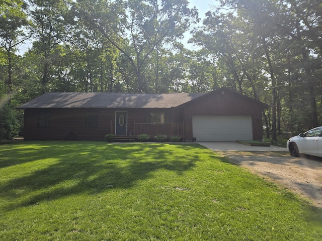 6560 Blue Lake Rd, Twin Lake, MI 49457 - view of front of property featuring driveway, a front lawn, an attached garage, and covered porch