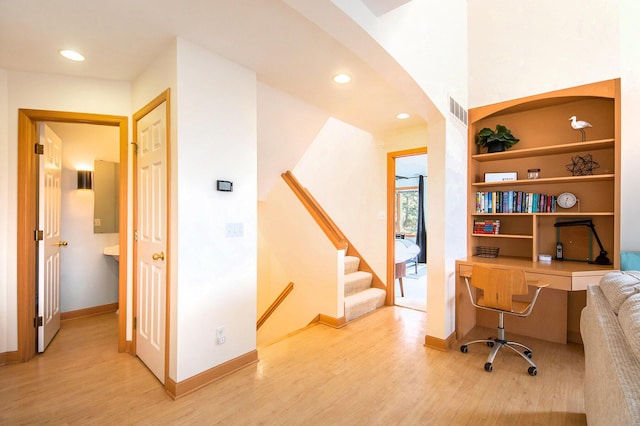 19148 Maiden Ln, Spring Lake, MI 49456 - office featuring light wood-type flooring, arched walkways, recessed lighting, and built in desk