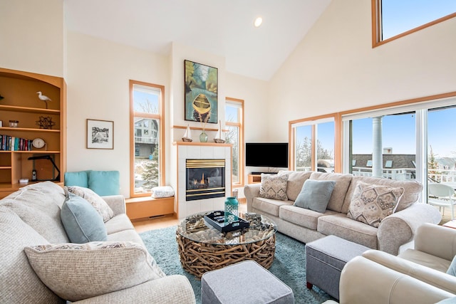 19148 Maiden Ln, Spring Lake, MI 49456 - living area featuring high vaulted ceiling, healthy amount of natural light, a tiled fireplace, and recessed lighting