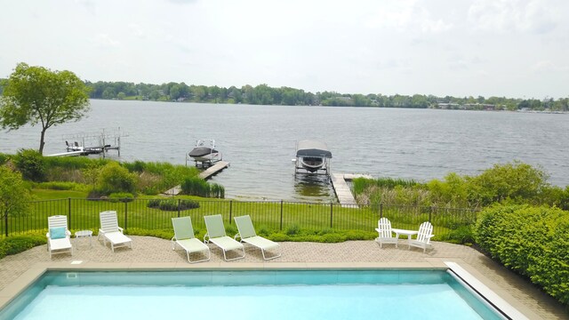 2634 Reeds Lake Ct SE, East Grand Rapids, MI 49506 - view of swimming pool with a water view and a patio area