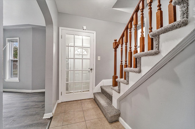 18308 Littlefield St, Detroit, MI 48235 - entryway with tile patterned floors, stairway, baseboards, and arched walkways