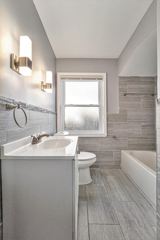 18308 Littlefield St, Detroit, MI 48235 - bathroom featuring a wainscoted wall, toilet, tile walls, and vanity