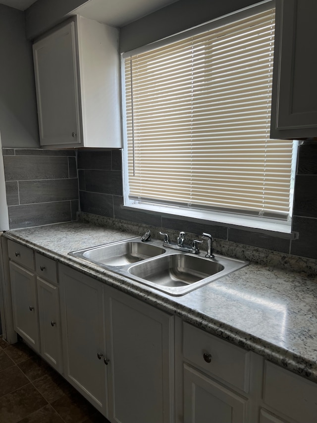 13900 Sussex St, Detroit, MI 48227 - kitchen with decorative backsplash, white cabinets, and a sink