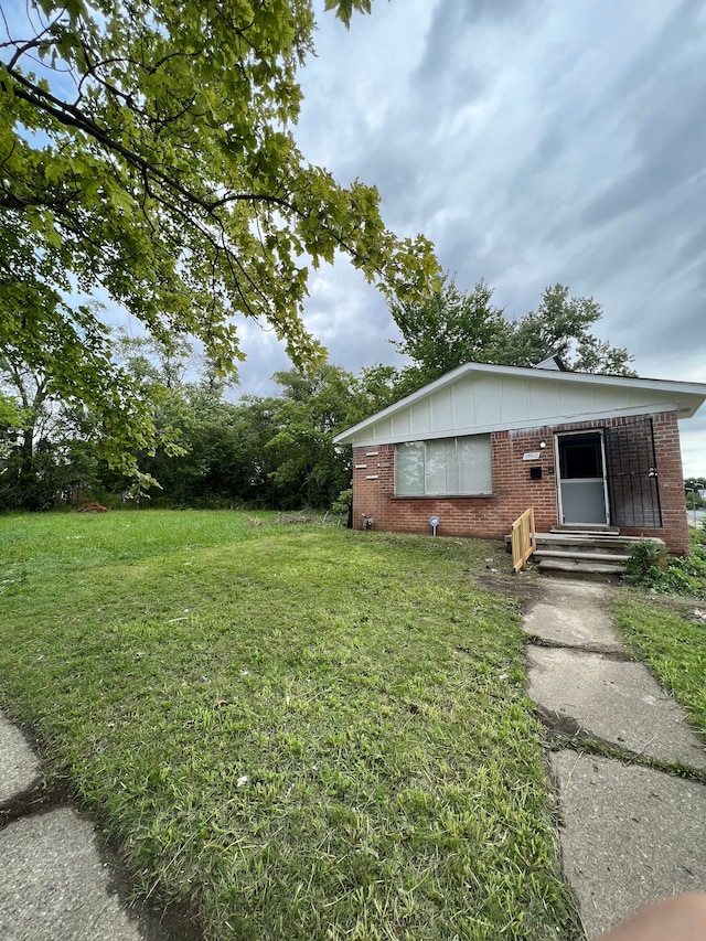 13900 Sussex St, Detroit, MI 48227 - exterior space with brick siding, entry steps, and a front lawn