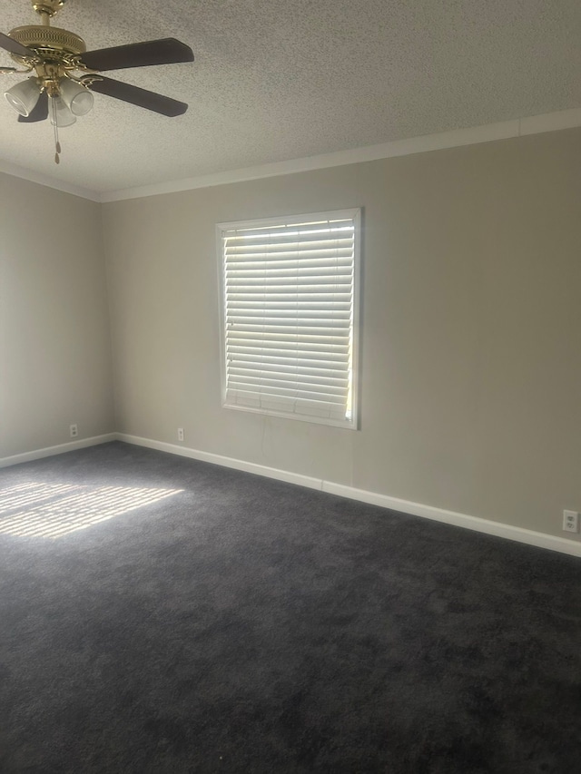unfurnished room with ornamental molding, a textured ceiling, dark carpet, and ceiling fan