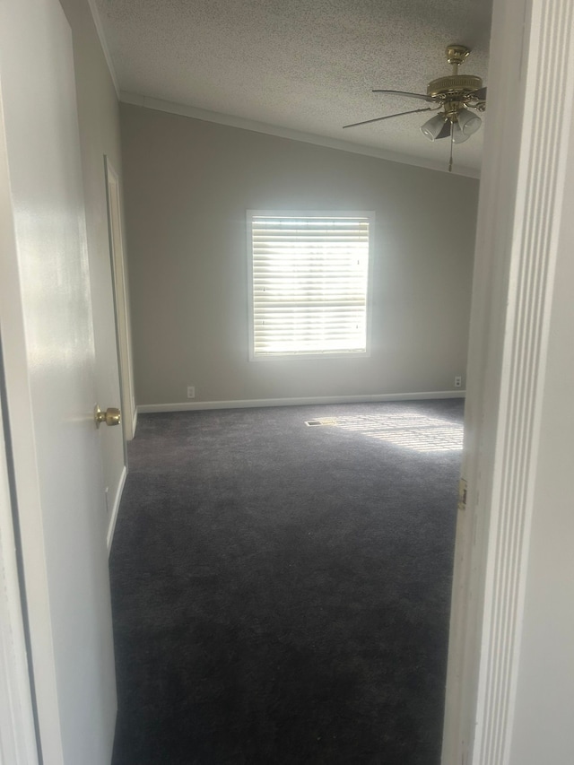 unfurnished room with crown molding, baseboards, a textured ceiling, carpet floors, and a ceiling fan