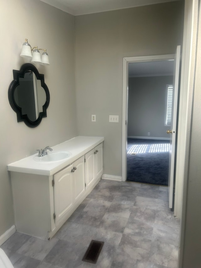 bathroom with vanity, baseboards, and visible vents