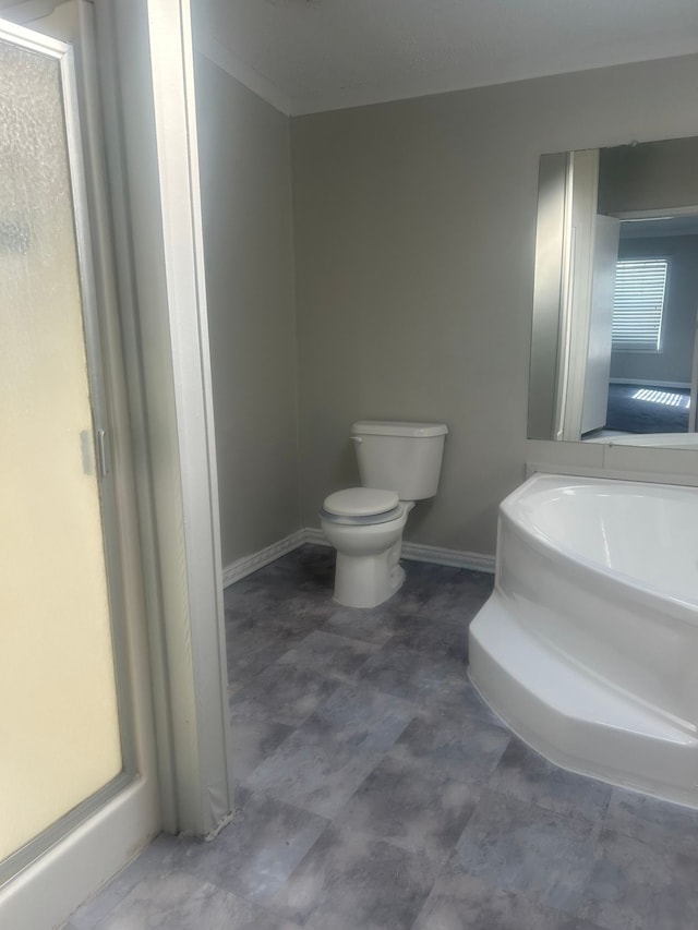 bathroom with toilet and baseboards