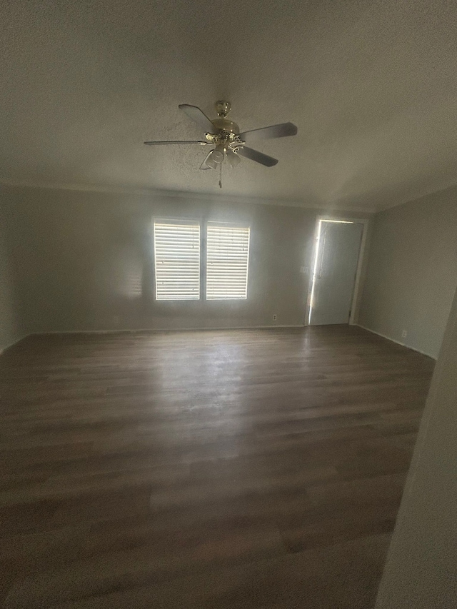 spare room with a textured ceiling, baseboards, ceiling fan, and wood finished floors