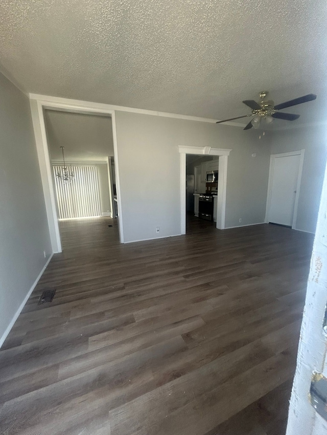 interior space featuring dark wood-style flooring, visible vents, a textured ceiling, and ceiling fan