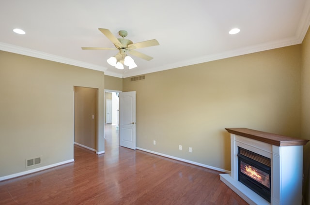 unfurnished living room featuring baseboards, visible vents, and wood finished floors