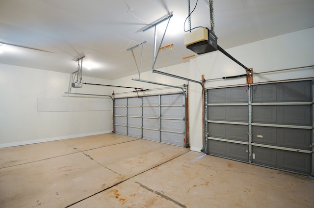 garage featuring baseboards and a garage door opener