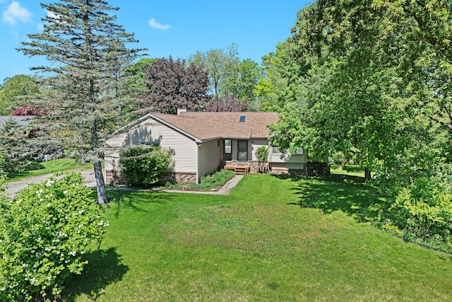 3380 Watersedge Dr, Brighton, MI 48114 - back of house featuring a yard and a chimney