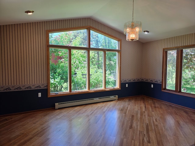 3380 Watersedge Dr, Brighton, MI 48114 - spare room with a baseboard heating unit, a chandelier, vaulted ceiling, wood finished floors, and wallpapered walls