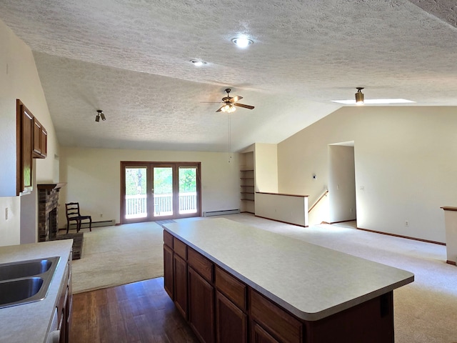 3380 Watersedge Dr, Brighton, MI 48114 - kitchen with a textured ceiling, open floor plan, a ceiling fan, vaulted ceiling, and carpet flooring