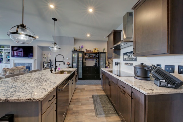 kitchen featuring black electric cooktop, dark brown cabinets, dishwasher, a sink, and wall chimney exhaust hood