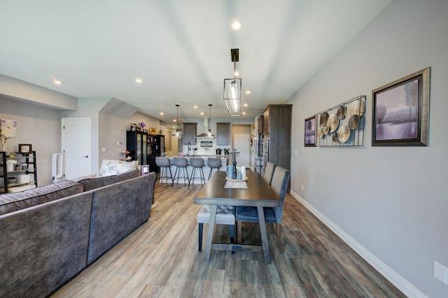 dining room with recessed lighting, wood finished floors, and baseboards