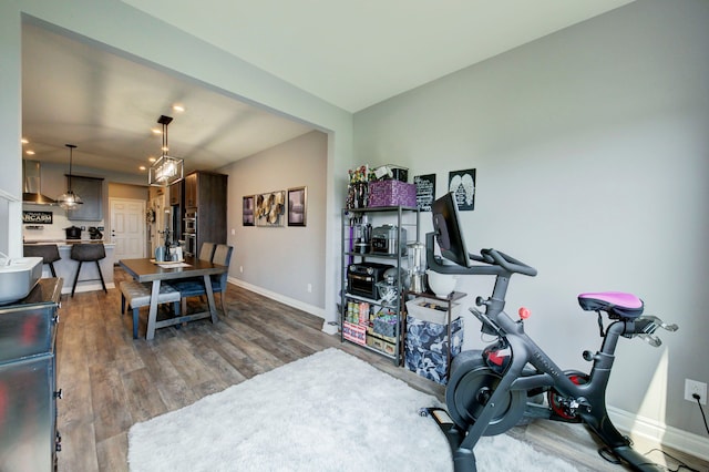 workout room featuring baseboards, recessed lighting, and dark wood-style floors
