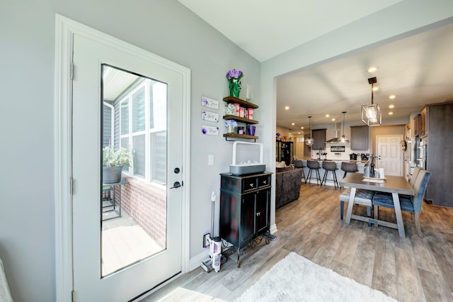 doorway to outside featuring recessed lighting, baseboards, and light wood-type flooring
