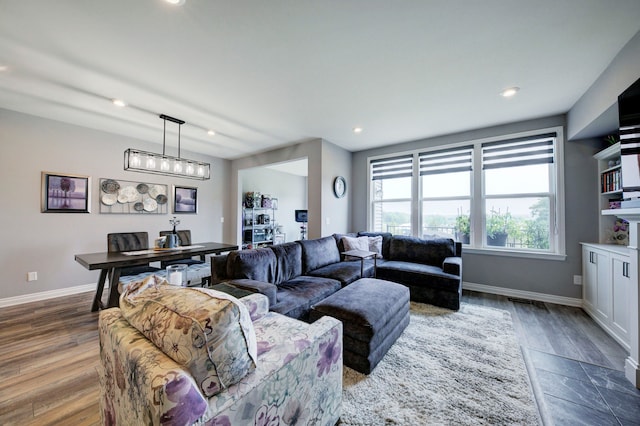 living room with recessed lighting, wood finished floors, and baseboards