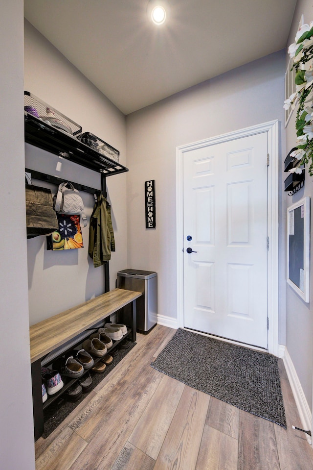 mudroom with wood finished floors and baseboards