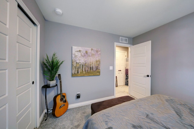 carpeted bedroom featuring visible vents and baseboards