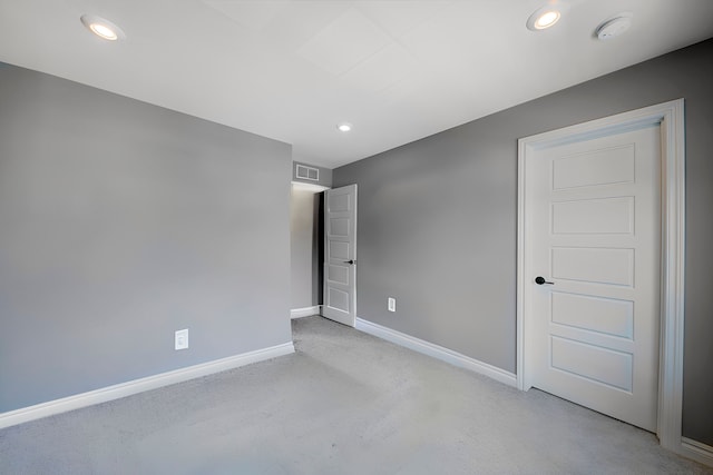 unfurnished bedroom with recessed lighting, visible vents, light colored carpet, and baseboards