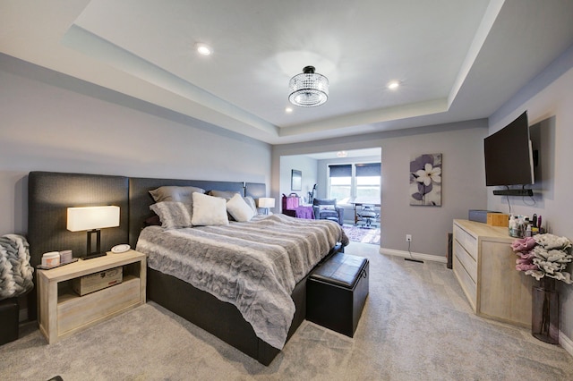 bedroom featuring recessed lighting, light carpet, a raised ceiling, and baseboards