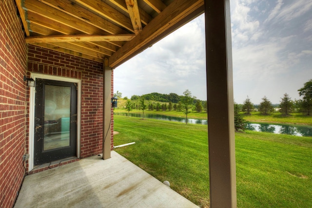 view of patio with a water view