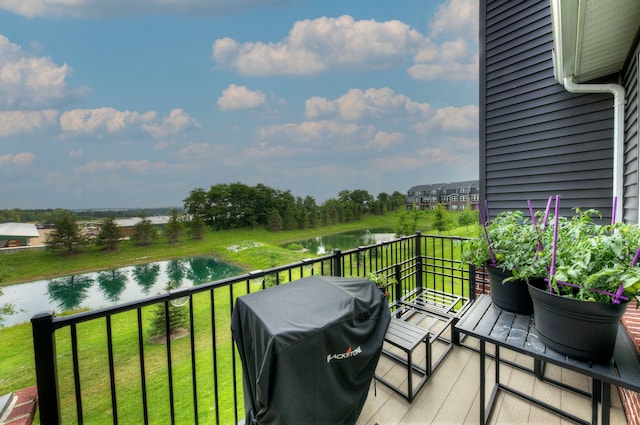 balcony with grilling area and a water view