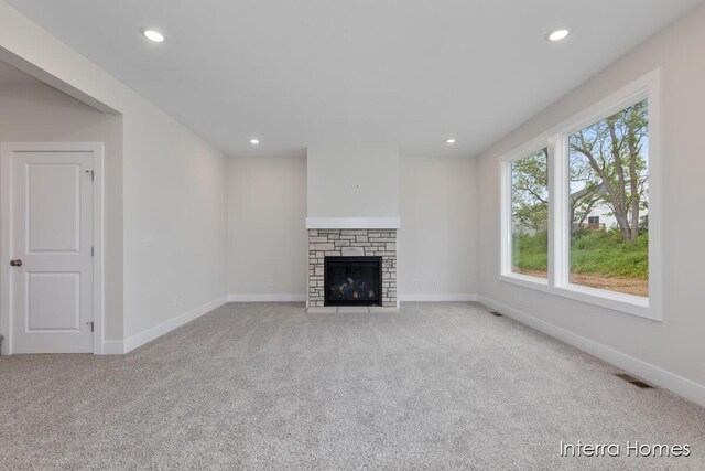 343 Seneca Ridge Dr Unit 40, Middleville, MI 49333 - unfurnished living room with carpet flooring, recessed lighting, and a stone fireplace