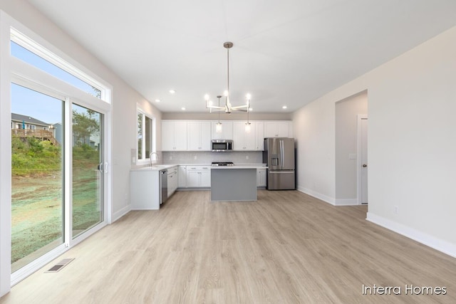 343 Seneca Ridge Dr Unit 40, Middleville, MI 49333 - kitchen featuring appliances with stainless steel finishes, a chandelier, light wood-style floors, light countertops, and recessed lighting