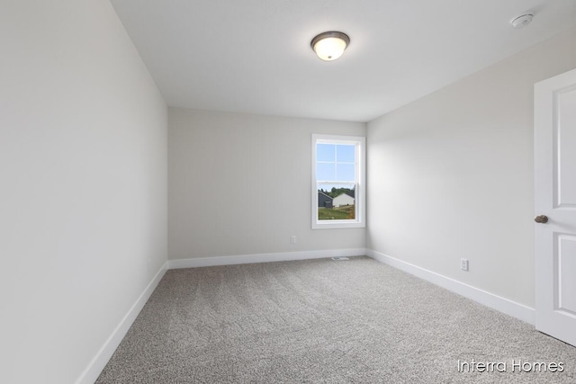 343 Seneca Ridge Dr Unit 40, Middleville, MI 49333 - carpeted empty room featuring baseboards and a smoke detector