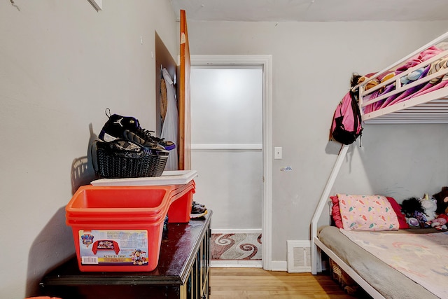 bedroom featuring visible vents and wood finished floors