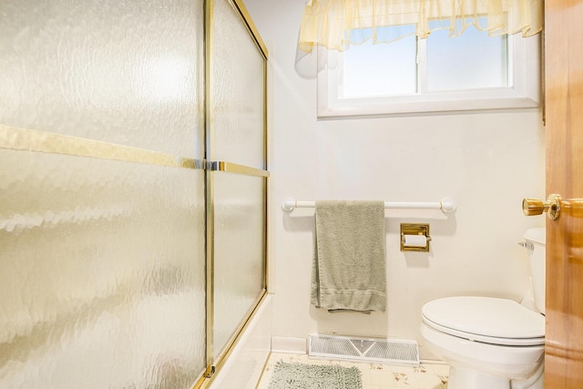 bathroom with visible vents, toilet, and shower / bath combination with glass door